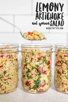 lemony artichoke and quinoa salad in mason jars with a spoon