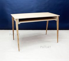 a small wooden desk with one drawer open