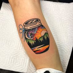 a person with a jar tattoo on their arm and the sky in it is filled with stars