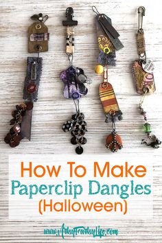 the words how to make paperclip dangles halloween hanging on a white wooden background