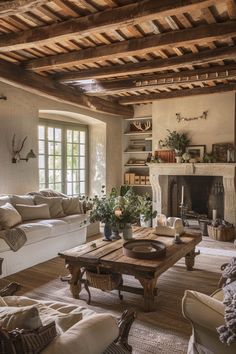 a living room filled with furniture and a fire place in the middle of a room