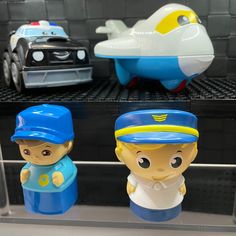 three plastic toys are on display in a case