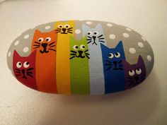 a painted rock with cats on it