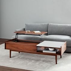 a living room with a couch, coffee table and end tables on the carpeted floor