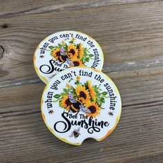 two sunflower magnets with words on them