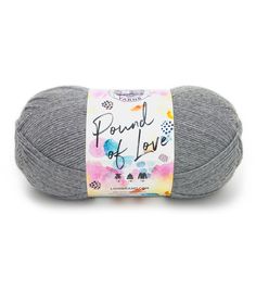 a gray ball of yarn with the words pound of love on it in white lettering