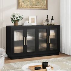 a black cabinet with glass doors in a living room