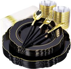 black and gold dinnerware set with golden rimmed forks, napkins and cups