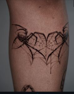 a spider web tattoo on the leg