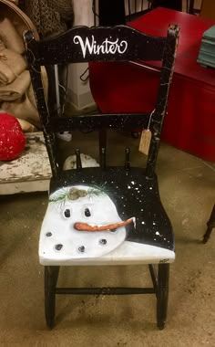 a chair that has been painted to look like a snowman with the word winter on it