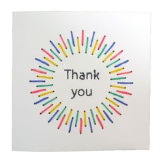 a thank you card with colored pencils in the center