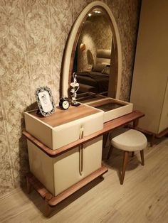 a dressing table with a mirror and stool