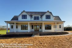 a large white house sitting on top of a dry grass covered field in front of a blue sky