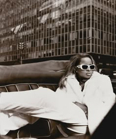 a black and white photo of a woman wearing sunglasses