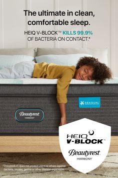 a child laying on top of a bed with the words, helock mattress