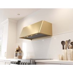 a gold hood over a stove in a kitchen