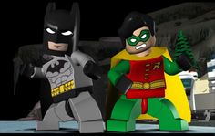 two lego batmans standing next to each other