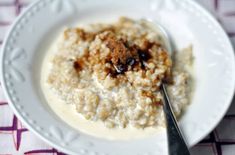 a white plate topped with oatmeal and raisins