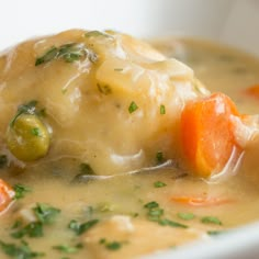 a white bowl filled with soup and vegetables