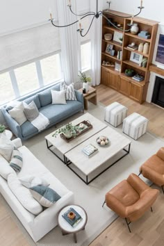 a living room with couches, chairs and a coffee table in front of a fireplace