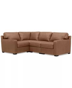 a brown sectional couch sitting on top of a white floor