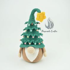 a crocheted stuffed animal with a christmas tree on it's head and nose