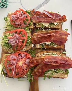 several slices of bread topped with bacon, tomatoes and lettuce