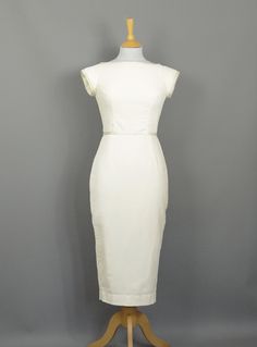 a white dress on a mannequin stand