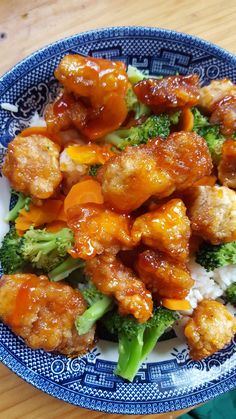 a blue and white plate topped with chicken and broccoli