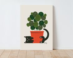 a cat is sitting next to a potted plant with green leaves in it on a wooden floor