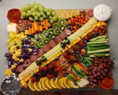 a platter filled with lots of different types of fruits and vegetables