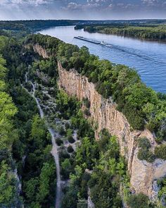 an aerial view of a river running between two cliffs