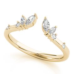 a yellow gold ring with three pear shaped diamonds