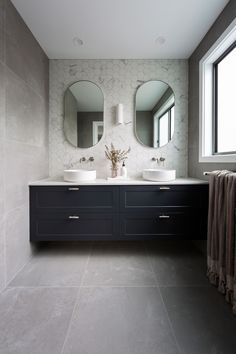 a large bathroom with two sinks and mirrors