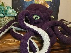 an octopus stuffed animal sitting on top of a table