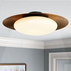 an overhead light fixture in a room with blue walls and white trimmings on the ceiling