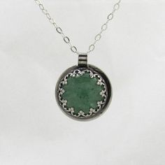 Featuring a green Aventurine stone surrounded by sterling silver, this pendant is similar to my cat's eye necklace but even more versatile. It looks great paired with my Aventurine ring as a set.   Each necklace comes with a 16 inch silver chain. If you require a longer chain, please include this information at checkout. For any other custom orders or requests, see the Contact page for details. All items come with free repair, resize and maintenance for the life of the product. Cat Eye Necklace, Aventurine Ring, Green Aventurine Stone, Aventurine Stone, Cameo Ring, Eye Pendant, Eye Necklace, Green Aventurine, Minimal Design