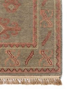 an old rug with fringes on it