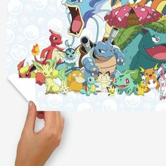 someone holding up a poster with pokemon characters on it