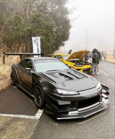 a black sports car parked on the side of a road