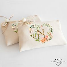 two personalized pillows with floral designs on them, one is for the letter m