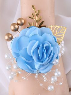 a close up of a wrist with a flower on it and pearls around the wrist