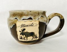 a moose themed coffee mug with the name minnesota on it