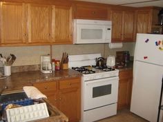 the kitchen is clean and ready for us to use it's new white appliances