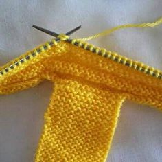 a pair of scissors is cutting through the stitchs on a yellow piece of fabric