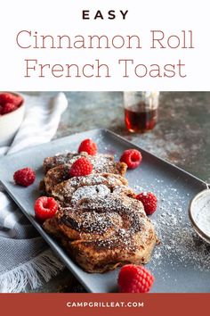 cinnamon roll french toast with raspberries and powdered sugar on top, sitting on a plate