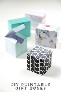 four small boxes with different designs on them and the words diy printable gift boxes