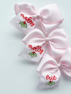 three bows with the words merry and holly on them