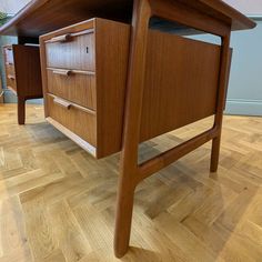 a wooden desk with two drawers on it