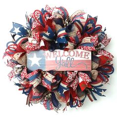 a wreath with the words welcome y'all on it and red, white, and blue ribbons